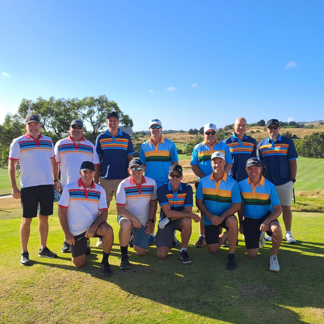 A crew of mates in matching retro-striped Golf Legends polos posing on a sunny fairway